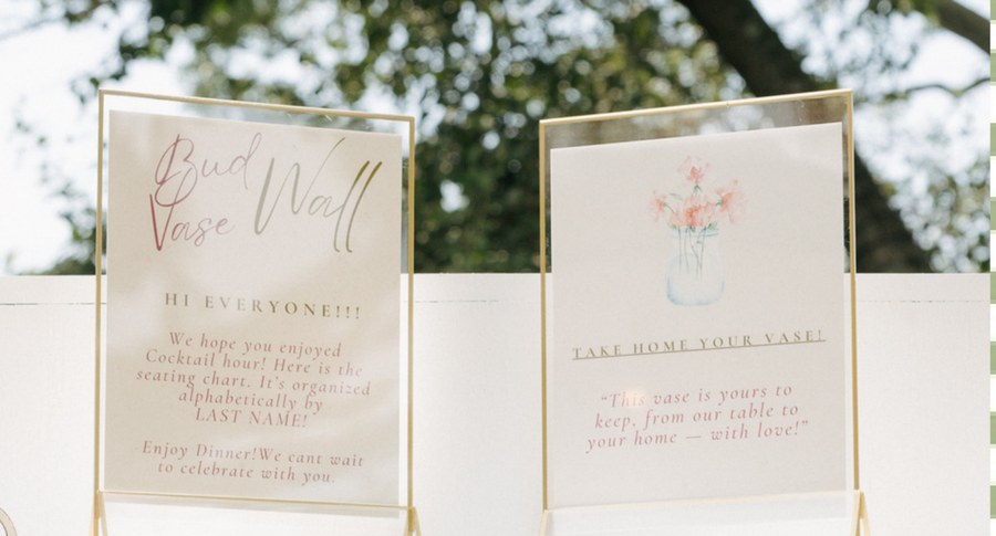Gold frames displaying wedding signage outdoors