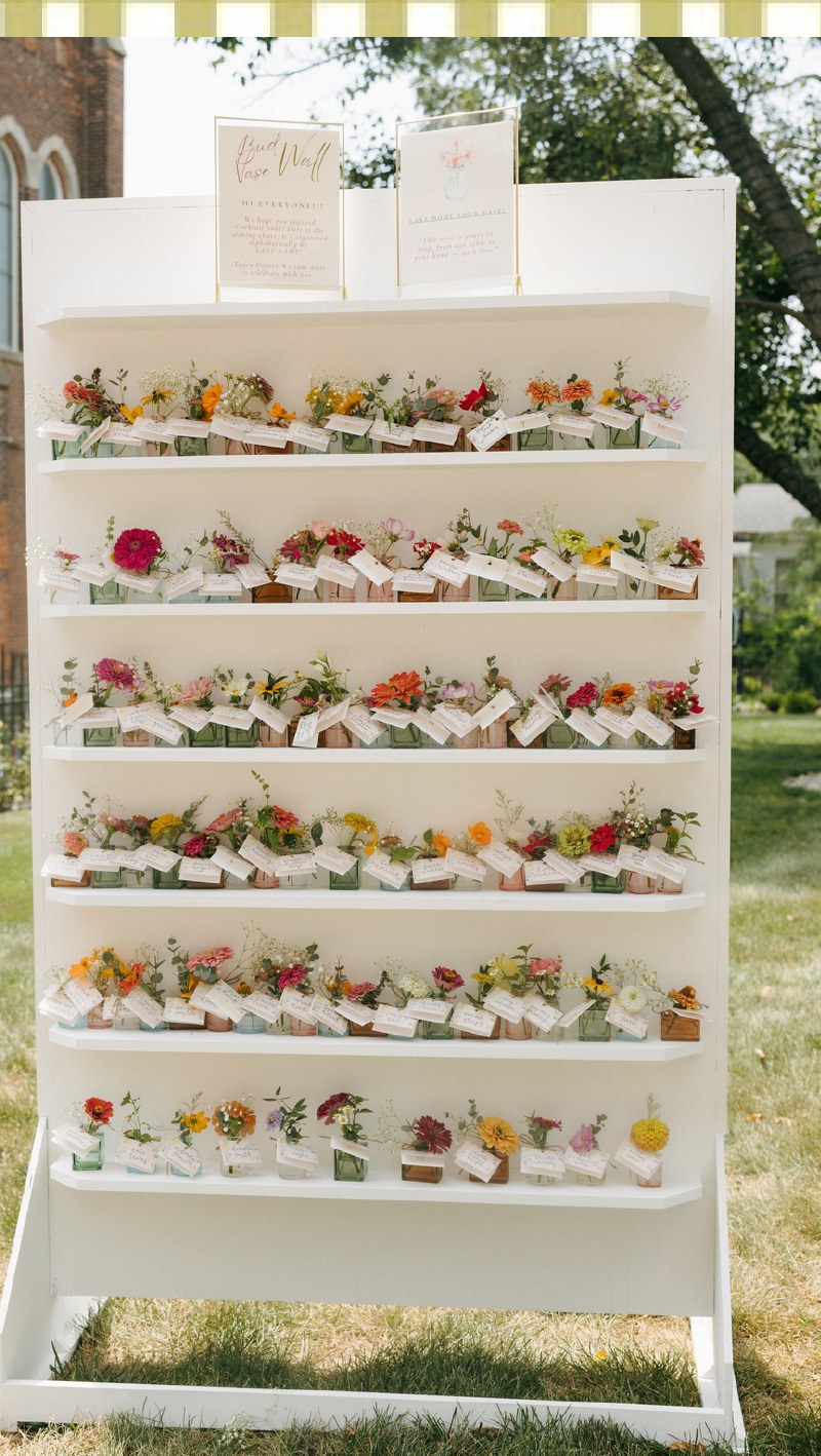 White shelving wall styled with a bud vase seating chart display