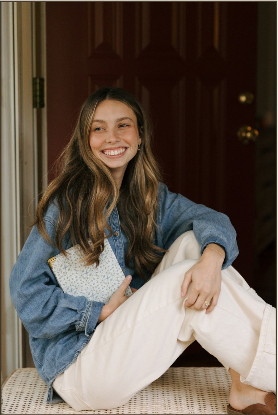 Founder of Woven Designs smiling on a front porch